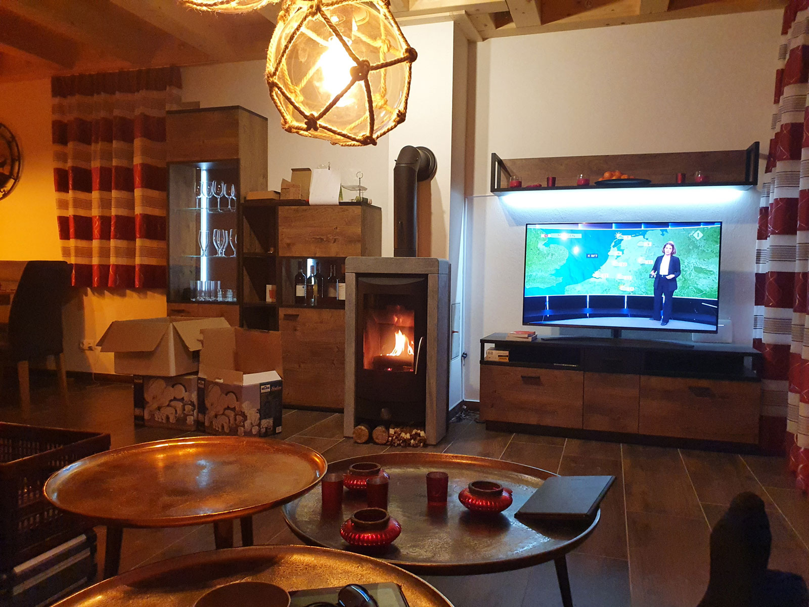 Living room sitting area with wood stove at Berghaus Edelhirsch